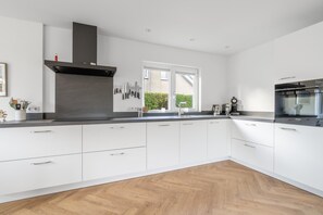 House | Private kitchen | High chair - Modernly Furnished Holiday Home for 6 People (De Koog)