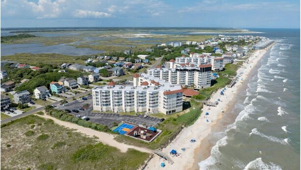 A coastal hotel with multiple buildings, a beach, and a view of the ocean. - Pet Friendly! Ocean Views/2 king suites/ sleeps 12 (North Topsail Beach)