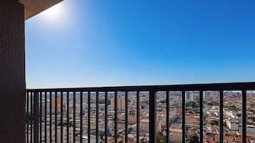 A balcony with a view of a cityscape.