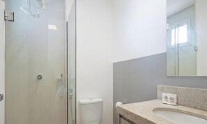 A bathroom with a glass shower enclosure, a toilet, and a sink with a marble countertop. - Apts in a Building With Pool and Gym - GRL (Anapolis)