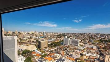 A cityscape with high-rise buildings, a mix of residential and commercial structures, and a clear blue sky.