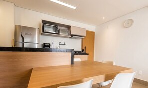 A modern kitchen with a built-in oven, microwave, and coffee maker. - Apts in a Building With Pool and Gym - GRL (Anapolis)