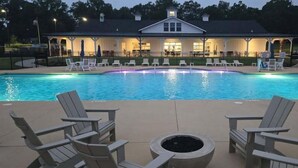 A swimming pool with lounge chairs and a covered area with tables and chairs. - Carolina Camp Cedar (Pickens)