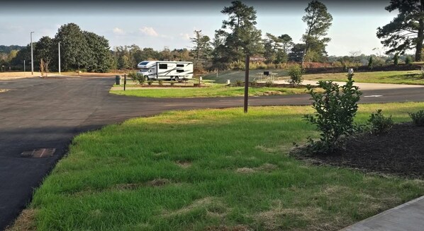 A campground with a white RV parked near a sign labeled "PALMETTO". - Carolina Camp Cedar (Pickens)