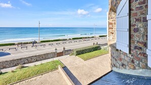 A stone building with a view of the beach and ocean.
