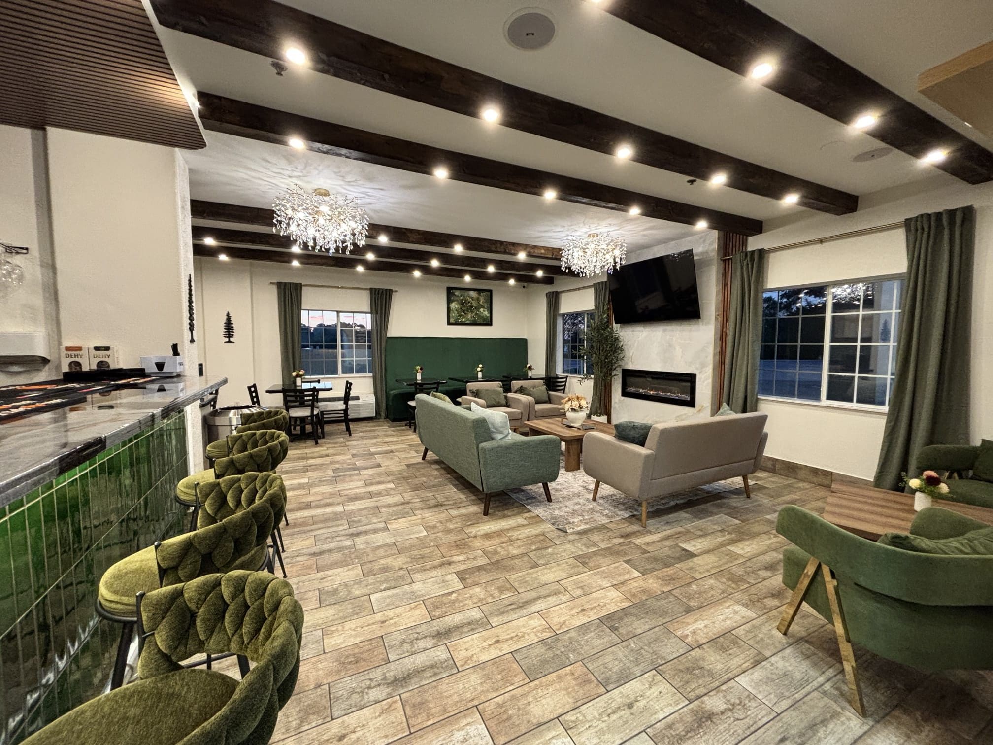 A modern interior with a bar area, seating, and a fireplace.