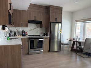 Fridge, microwave, oven, stovetop - Canal view Luxury modern legal walkout suite near airport (Airdrie)