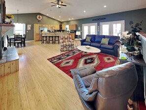 A spacious living area with a sofa, coffee table, and patterned rug. - Sunrise Vista (Ruidoso)