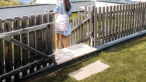 A person standing on a wooden deck overlooking a mountainous landscape. - Aparthotel Bacher (Bressanone)