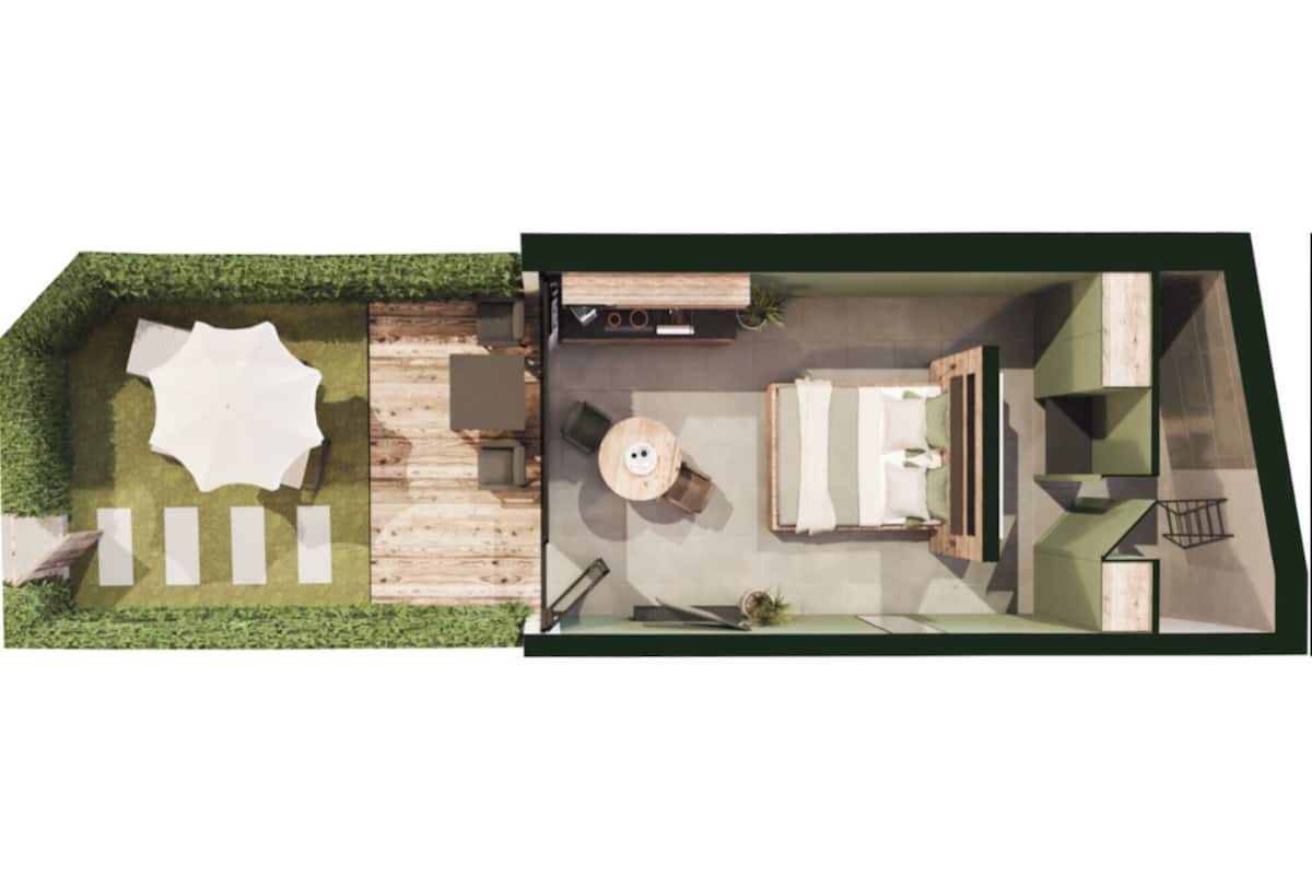 A modern interior with a dining area, kitchen, and a small outdoor space with a table and chairs.