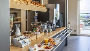 A modern breakfast buffet with various food items and a coffee station. - B&B Hotel Valence Sud (Valence)