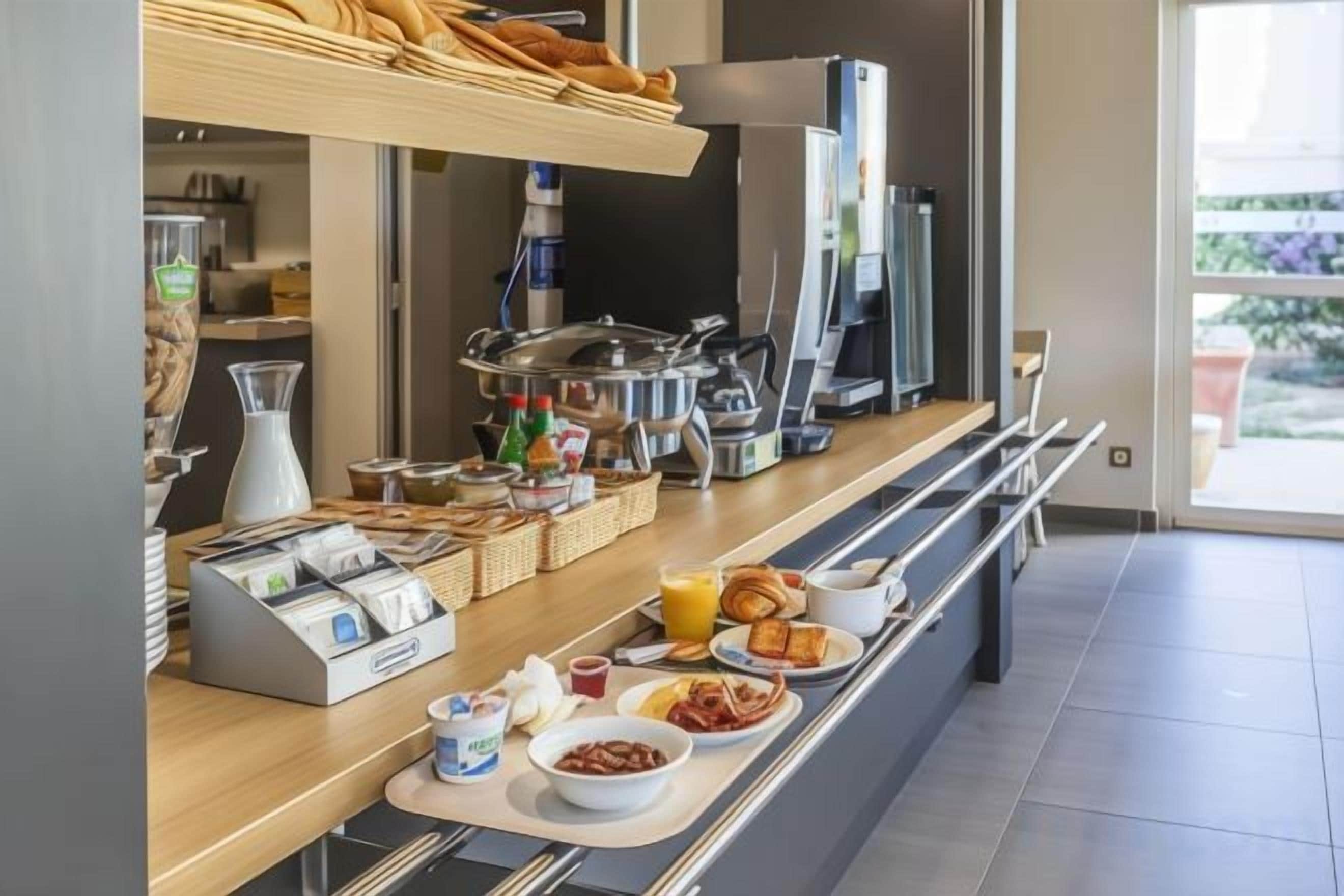 A breakfast buffet with various food items and beverages.
