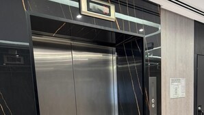 A modern elevator with a metallic finish and a control panel on the right side. - Casa Nova (Dubai)