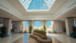 A spacious lobby with a high ceiling, large windows, and a central seating area. - Sataya Resort Marsa Alam (Qesm Marsa Alam)