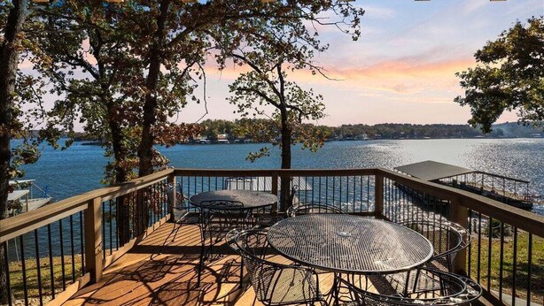 A wooden deck with outdoor furniture overlooking a lake. - 2 Lakefront Homes: Wide Decks, Great View (Gravois Mills)