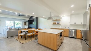A modern kitchen with wooden cabinets, a central island, and stainless steel appliances. - Mountain Modern 3-bedroom Lower DV/Old Town Condo (Park City)