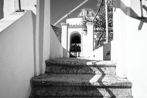 A staircase leading to a building entrance with a balcony.