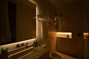 A modern bathroom with a large mirror, a sink, a toilet, and a shower. - Colonial loft in Cartagena old town (Cartagena)