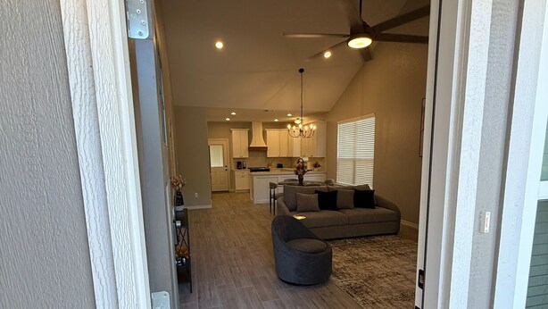 A modern interior with a dining area, kitchen, and living room.