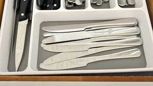 A drawer containing various utensils including knives, forks, spoons, and chopsticks. - Serene 2-bedroom apartment in Provo (Provo)