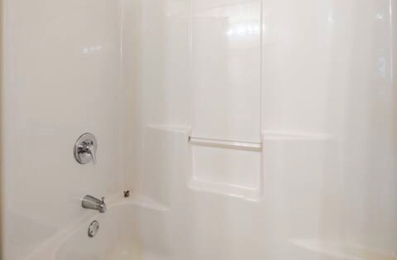 A bathroom with a bathtub, a shower, and a toilet.