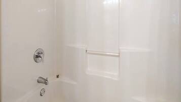 A bathroom with a bathtub, a shower, and a toilet.