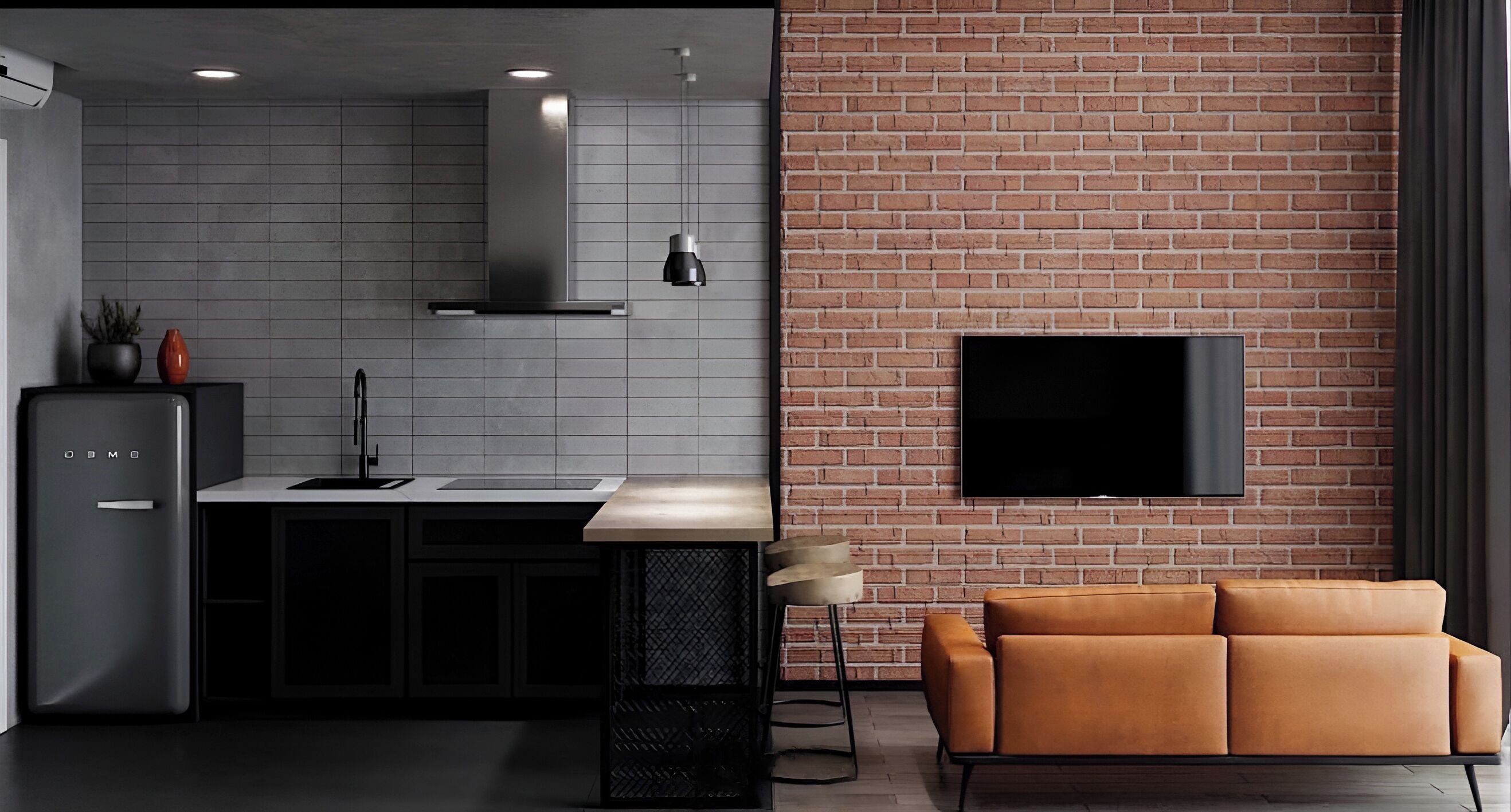 A modern kitchen with a grey tiled backsplash, a stainless steel range hood, and a black countertop. A flat-screen TV is mounted on a brick wall to the right.