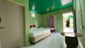 A room with a bed, a small table, and a door. - Zackry Guesthouse (Langkawi)