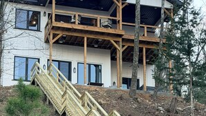 A two-story building with a wooden staircase leading to a balcony.