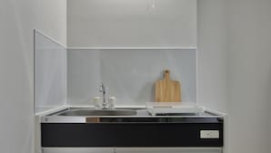 Eine moderne Küche mit integriertem Spülbecken, einer Holztischplatte und einer schwarzen Arbeitsplatte.