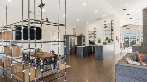 A modern kitchen with stainless steel appliances, a central island, and a dining area with a wooden table and chairs. - Contemporary Hideout - 7min to Clemson University (Central)
