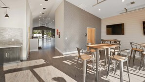 A modern kitchen with a white brick backsplash, stainless steel appliances, and a wooden countertop. - Contemporary Hideout - 7min to Clemson University (Central)