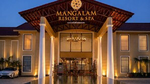 A resort with a large pool, a covered entrance, and a sign reading 'Mangalam Resort & Spa'. - Mangalam Resort and Spa - Member of Absolute Collection   (Gangapur)