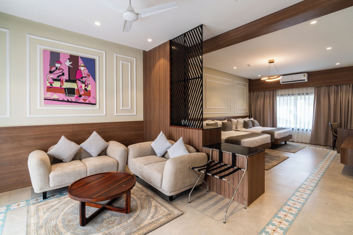 A modern living room with sofas, a coffee table, and a decorative wall piece.