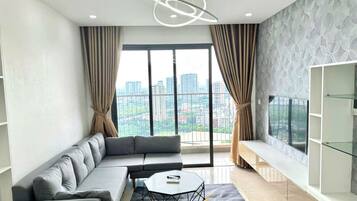 Deluxe Apartment, Balcony, City View | Living area | 60-inch Smart TV with satellite channels, Netflix, streaming services