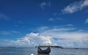 A boat in the water with a clear sky and a location marker labeled "Marina Bay". - Marine Bay Glamping Beach Resort (Cox's Bazar)