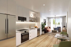 A modern kitchen with white cabinetry, a built-in oven, and a microwave. There is a dining area with a table and chairs, and a living room with a sofa and a coffee table.