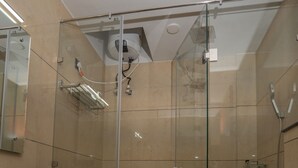 A modern bathroom with a glass-enclosed shower, a white sink, and a toilet. - Corbett Hidden Paradise (Ramnagar)