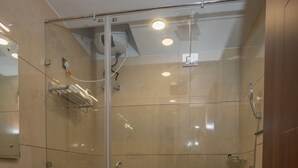 A modern bathroom with a glass-enclosed shower, a white sink, and a toilet. - Corbett Hidden Paradise (Ramnagar)