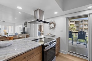 A modern kitchen with a built-in stove, oven, and stainless steel range hood.