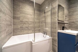 Shower, hair dryer, towels, shampoo