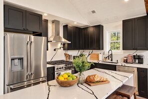 Chef's kitchen with ZLINE appliances and island seating for 4