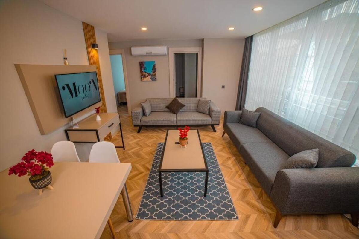 A modern living room with a sofa, a coffee table, and a TV.