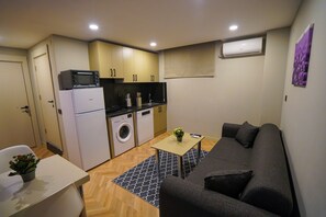 Economy Apartment, 1 Bedroom | Living area | 43-inch Smart TV with satellite channels, Netflix, streaming services