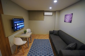 Economy Apartment, 1 Bedroom | Living area | 43-inch Smart TV with satellite channels, Netflix, streaming services - Moon Suites (Antalya)