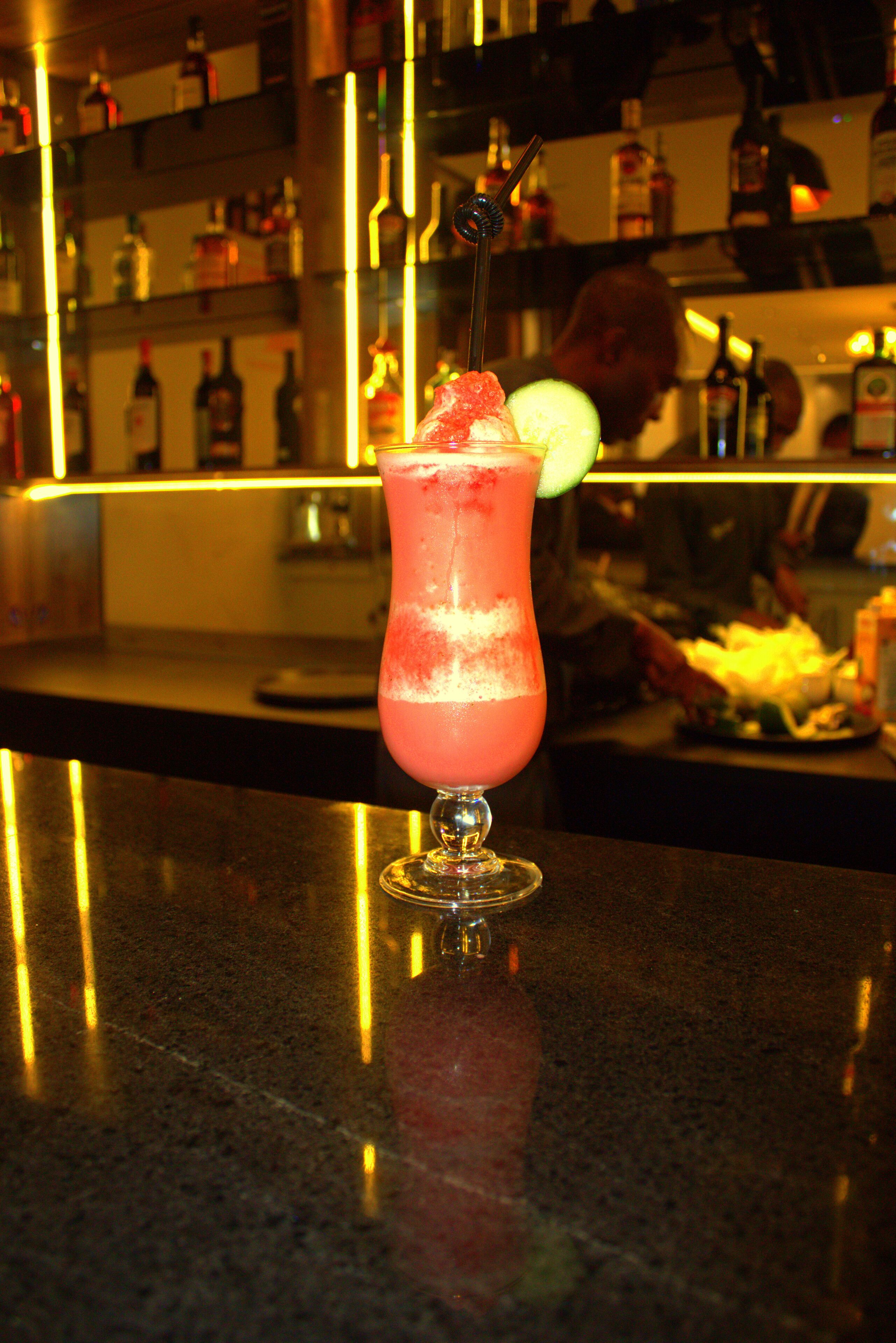 A bar setting with a cocktail on the counter.