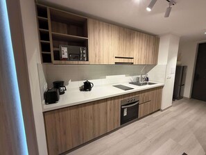 Fridge, microwave, stovetop, coffee/tea maker
