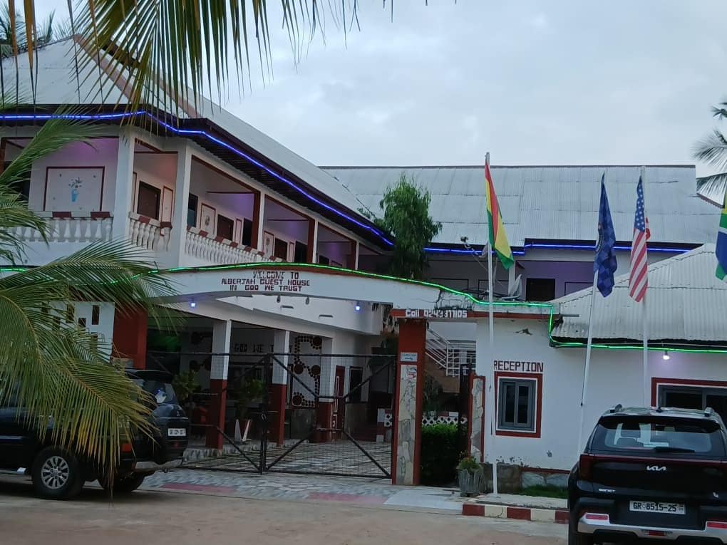A building with a reception area, a gated entrance, and flags.
