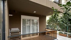 A modern apartment with a balcony, a sliding glass door, and a small outdoor seating area. - Sun Suite (Antalya)