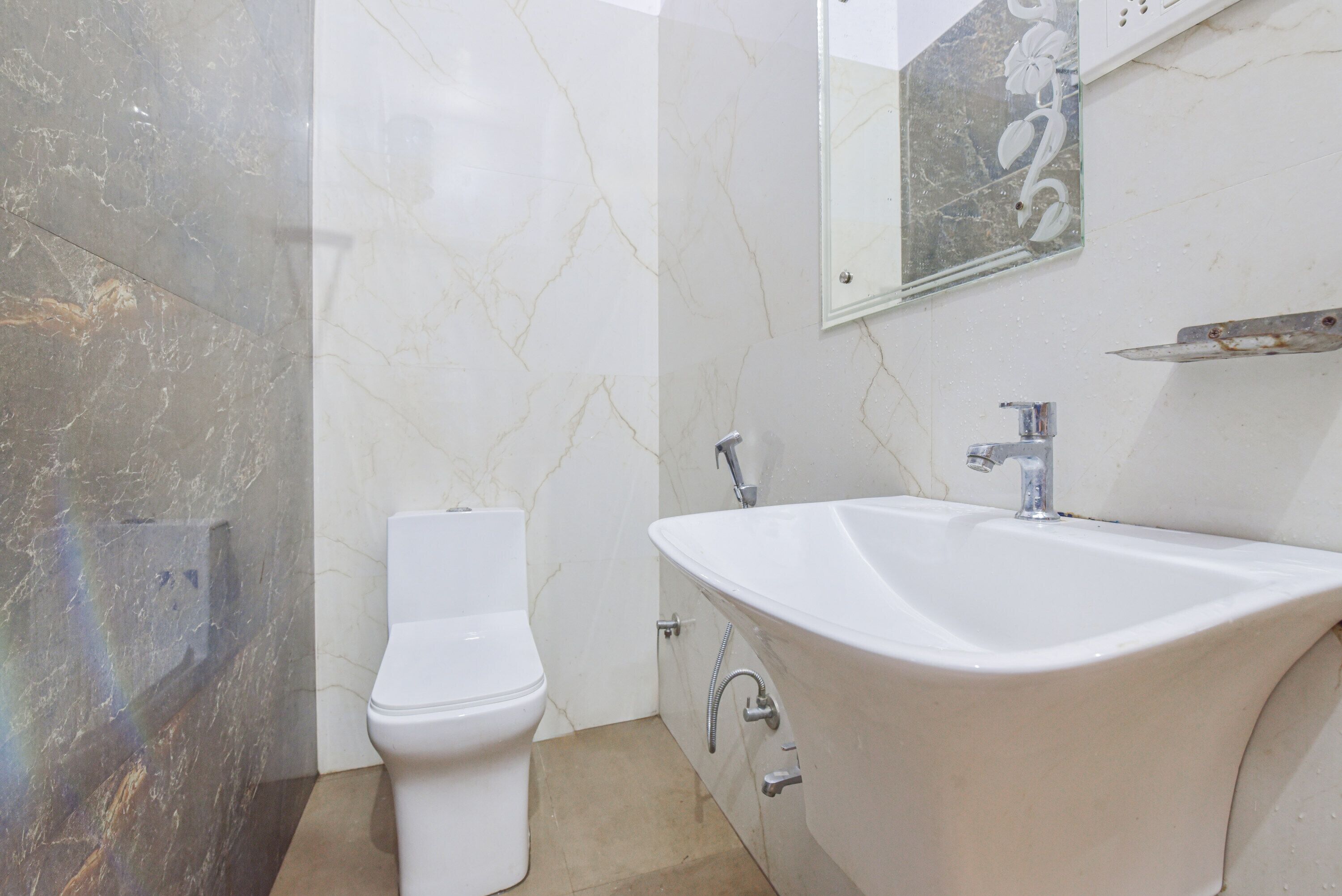 A bathroom with a toilet, a bathtub, and a sink.